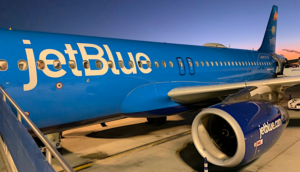 JetBlue airplane waiting on tarmac with all blue colorway