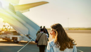 woman boarding plane; Vlad Teodor/Shutterstock