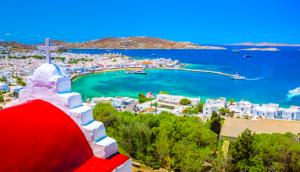 View of Mykonos harbor from hill with church