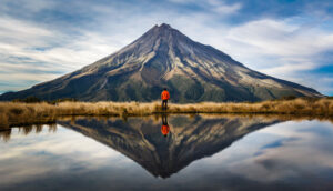climber looking at taranaki volcano in the north island of New Zealand