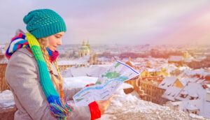 girl searching map during winter in prague, czech republic, europe