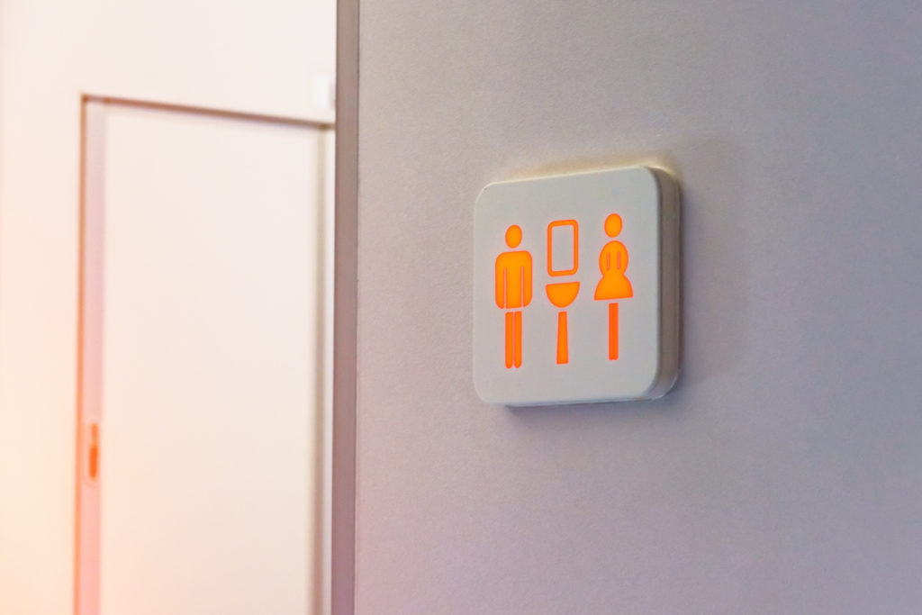 Red airplane bathroom sign signaling that the bathroom is occupied