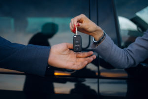 People exchanging keys for an airport car rental
