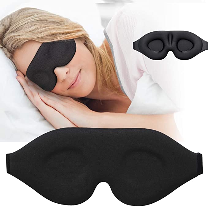 Woman sleeping while wearing black sleep mask