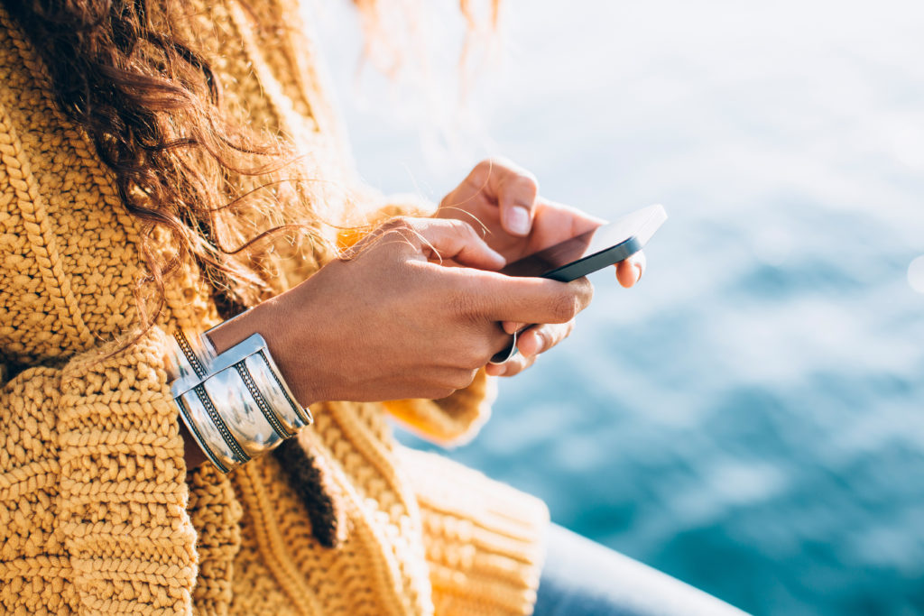 Woman in a yellow sweater texting