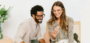 Woman and man smiling at phone