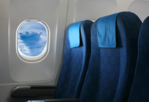Two airplane passenger seats and an airplane window