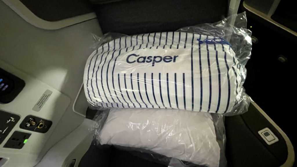 Casper mattress pad and pillow on American Airlines plane seat