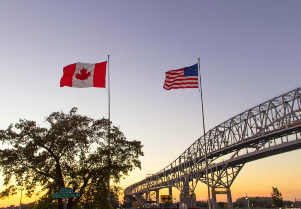 United States and Canadian flags at the Canadian/US border