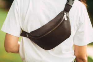 Person wearing a waist bag diagonally across their back