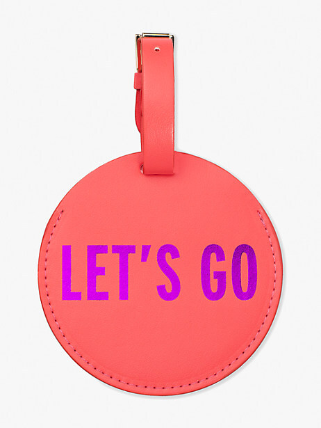 Pink circular luggage tag that says "Let's Go" in purple letters