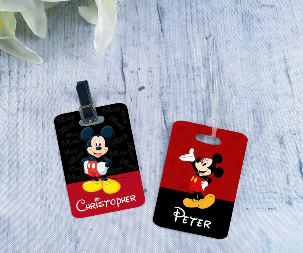 Two luggage tags with Mickey Mouse on them