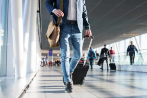 Man walking through airport with luggage
