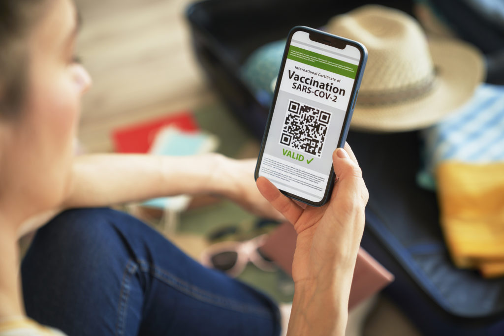 Woman holding digital vaccination passport on her phone