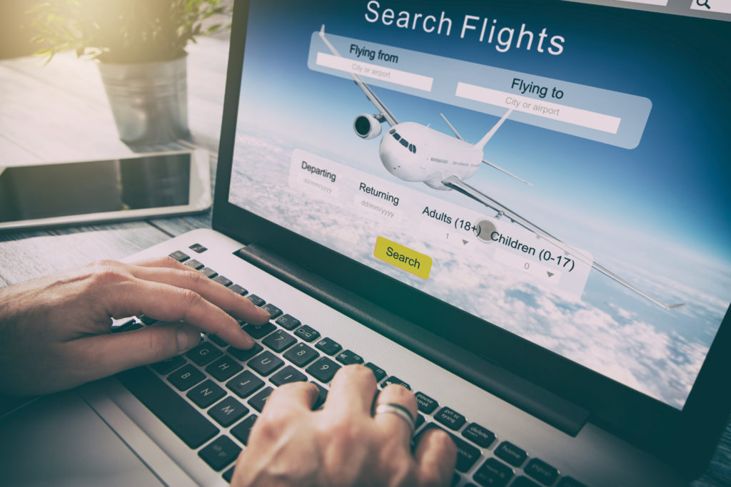 Person searching for flights on laptop