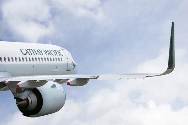 Cathay Pacific plane flying in blue skies