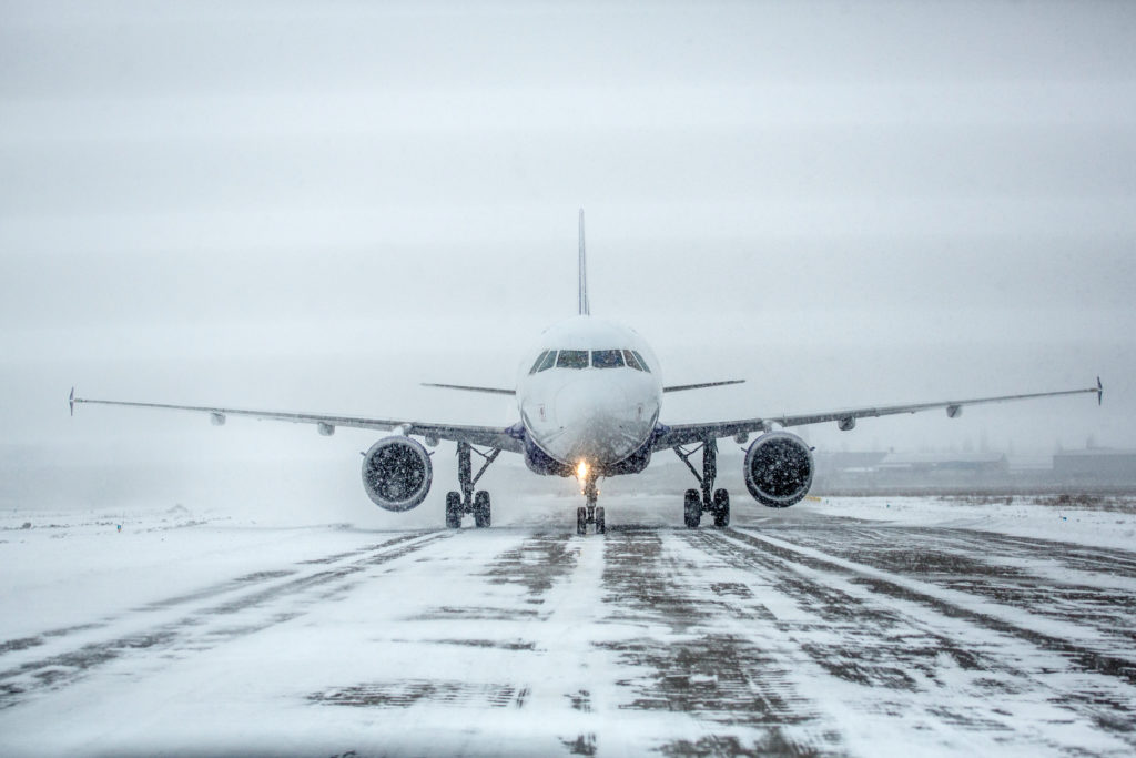 Plane on runway in snow