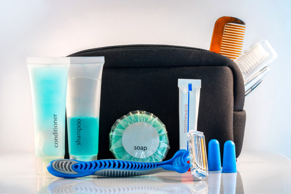 Close-up of toiletry bag with toiletries displayed in front