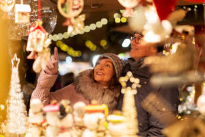 A couple looks at items in a stand at the Tallinn Christmas Market in Estonia