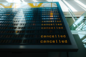 Departures board at airport showing multiple cancelled flights