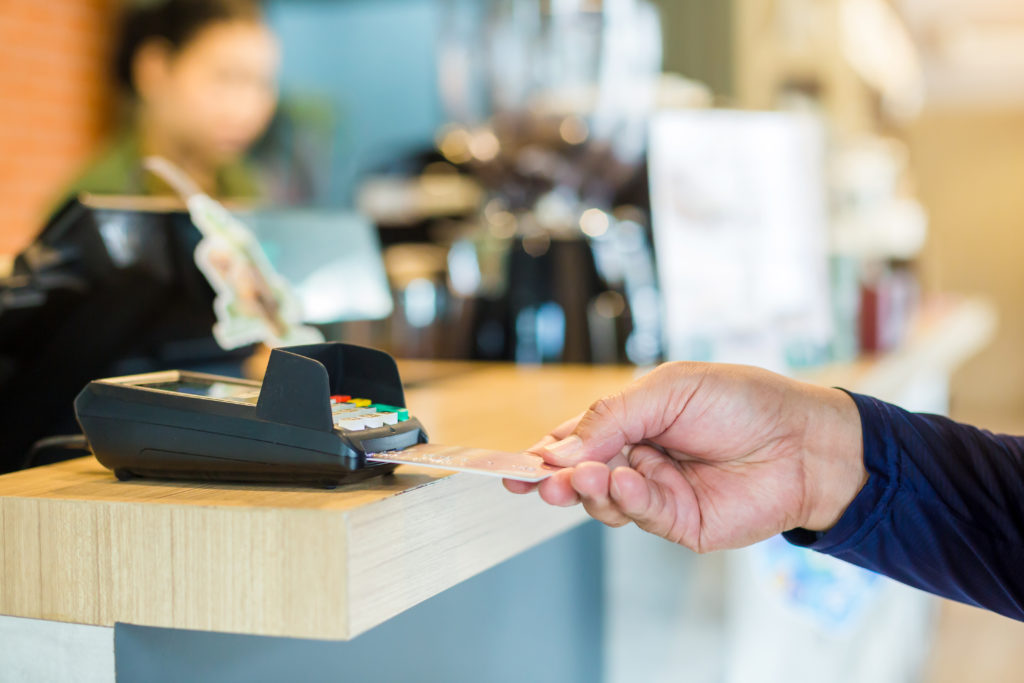 Close-up of hand making a purchase with credit card