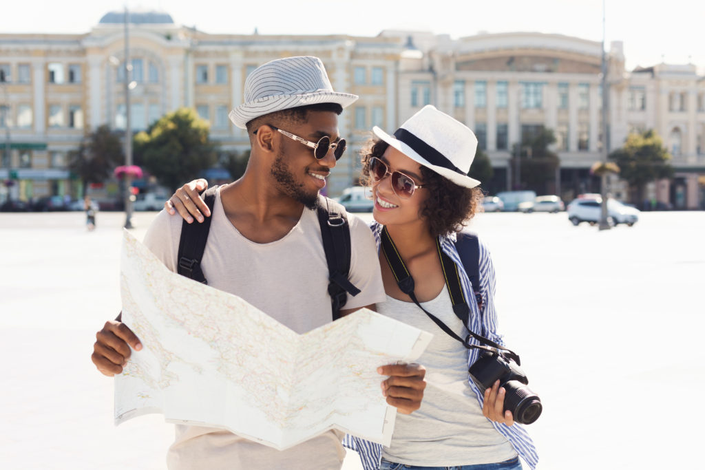 Couple walking through a city while looking at a map