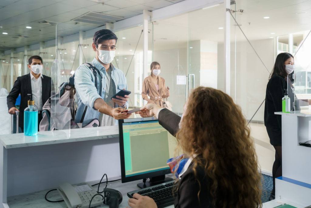 Passenger handing passport to airport gate agent